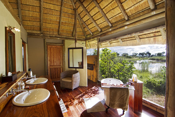 A light and airy bathroom with endless views out over the floodplains at Kwando Lagoon Camp in Botswana