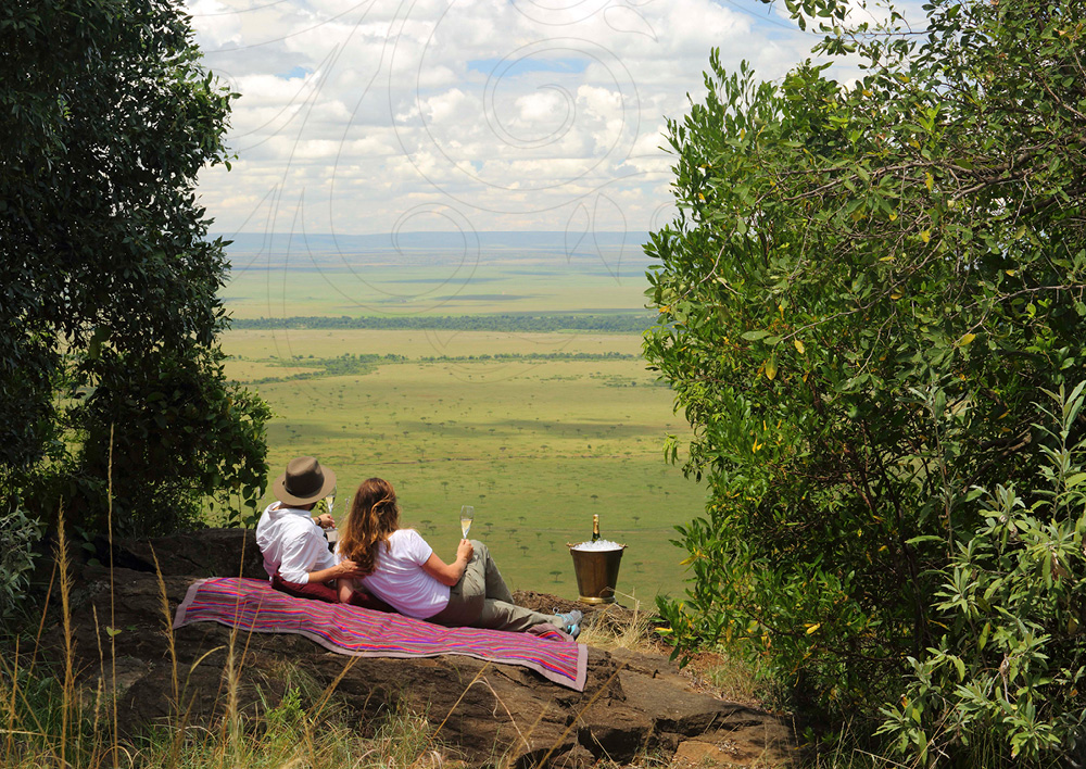 A couple surveying the veiw on a honeymoon safari in the Serengeti